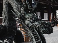 black dragon statue near brown building