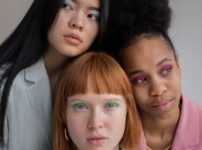multiracial women with bright eyeshadows in studio